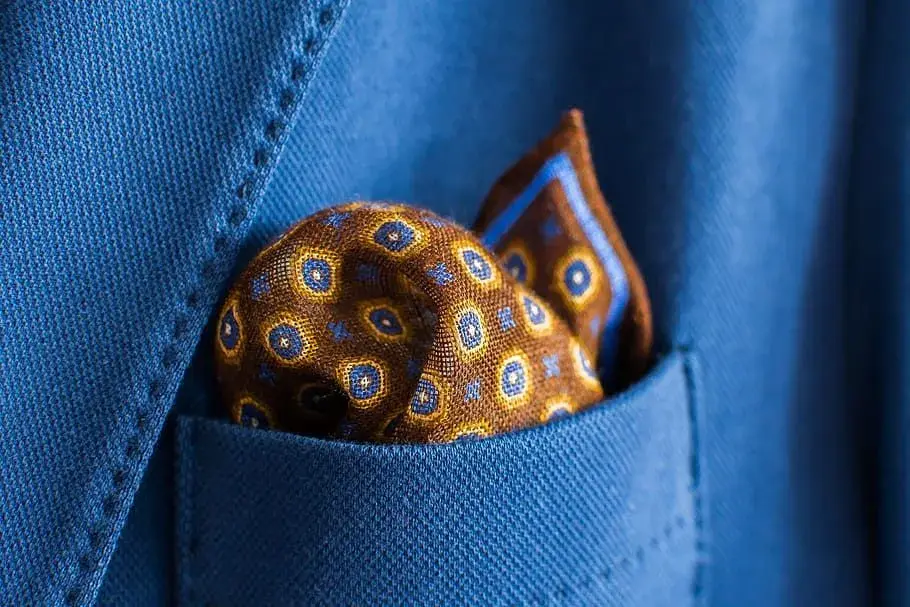 Person cleaning eyeglasses with a microfiber cloth